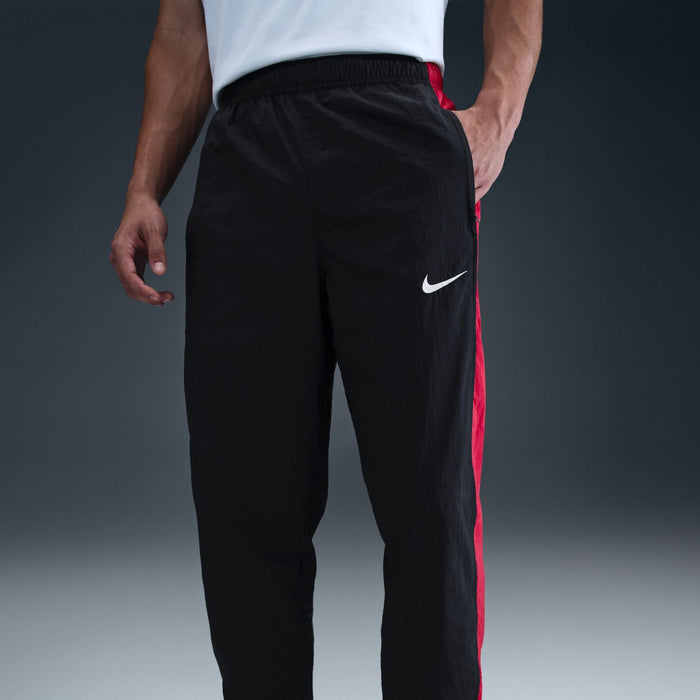 Men's black track pants, red side stripe, Nike swoosh on thigh