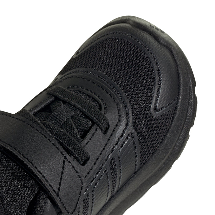 Toddler black sneaker close-up of textured upper and stitched strap overlays