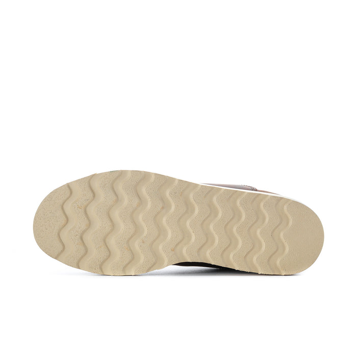 Outsole of women’s wide Chelsea boots with wavy tread, light rubber color