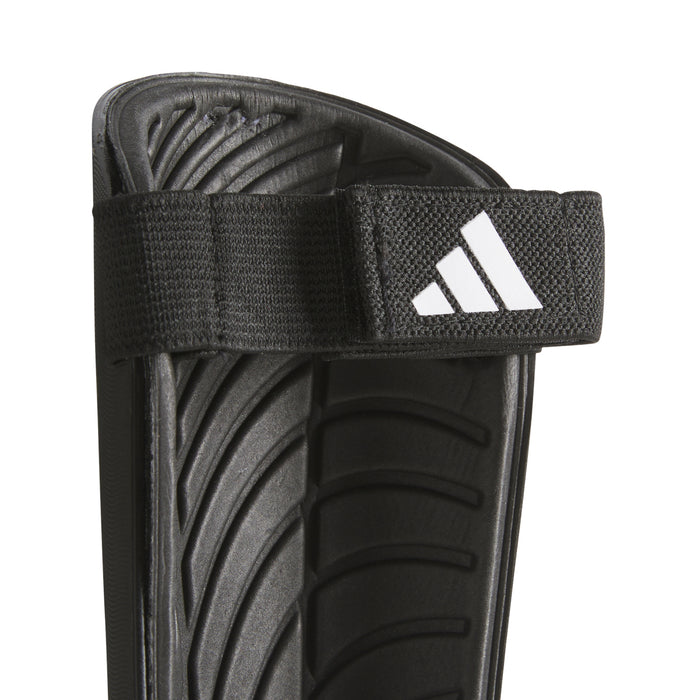 Black shin guard with hook-and-loop strap and adidas logo on front