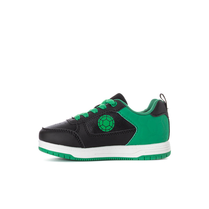 Kids TMNT court sneaker side view with green toe panel and turtle emblem
