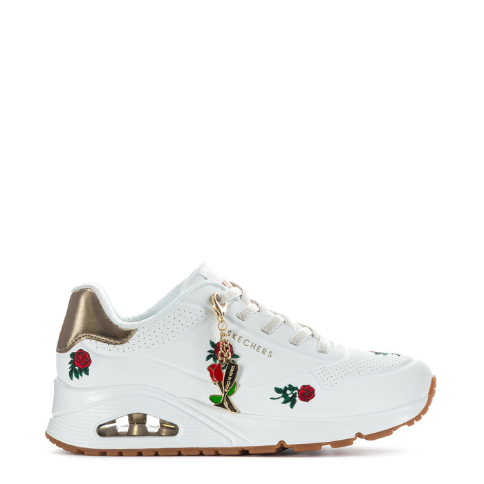 White women's sneaker with gold collar, red rose patches, lace-up, gum rubber sole