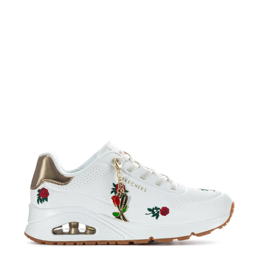 White women's sneaker with gold collar, red rose patches, lace-up, gum rubber sole