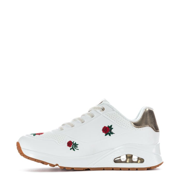 White women's lace-up sneaker with red rose embroidery and metallic gold heel detail