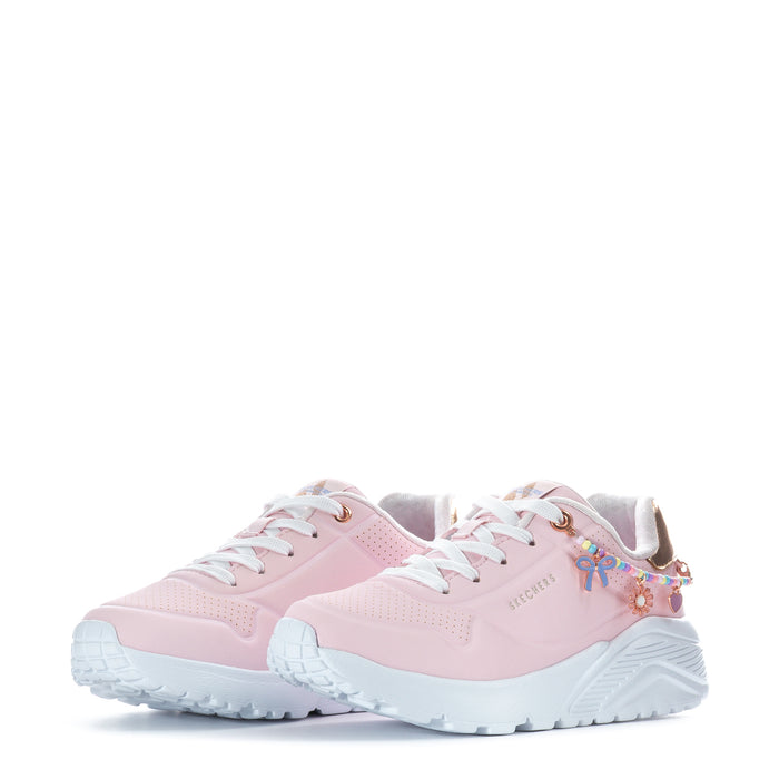 Kids pink sneakers, front view with colorful charm on side