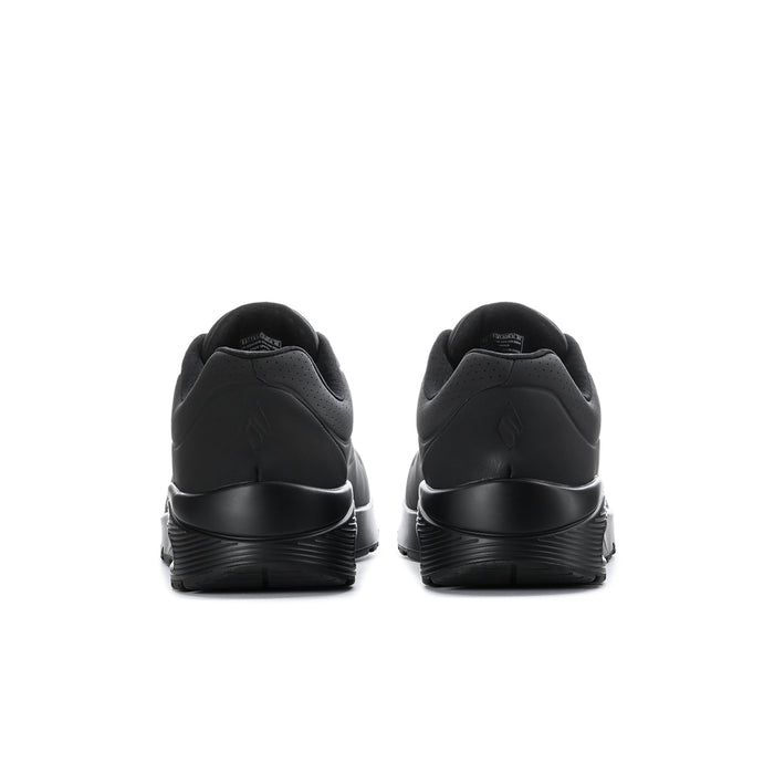 Men's black wide sneakers from the heel view with supportive rear collar and cushioned sole
