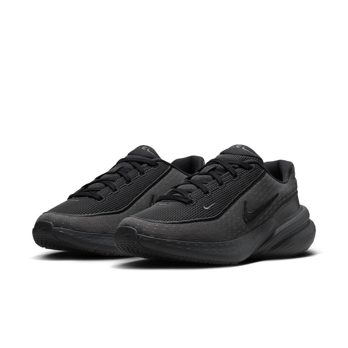 Women's dark lace-up running shoes, pair view with Nike swoosh and sculpted midsole