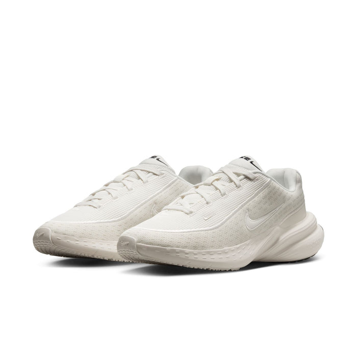Women's lace-up running shoes, side view of light knit upper and thick white foam sole