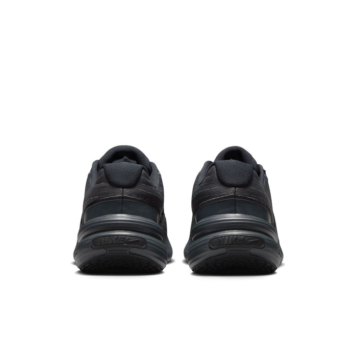 Women's black sneakers, rear view with heel pull tab and sculpted rubber sole