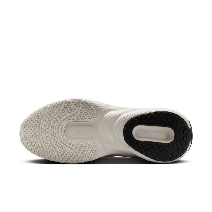 Women's running shoe, outsole view with grippy tread and dark heel insert
