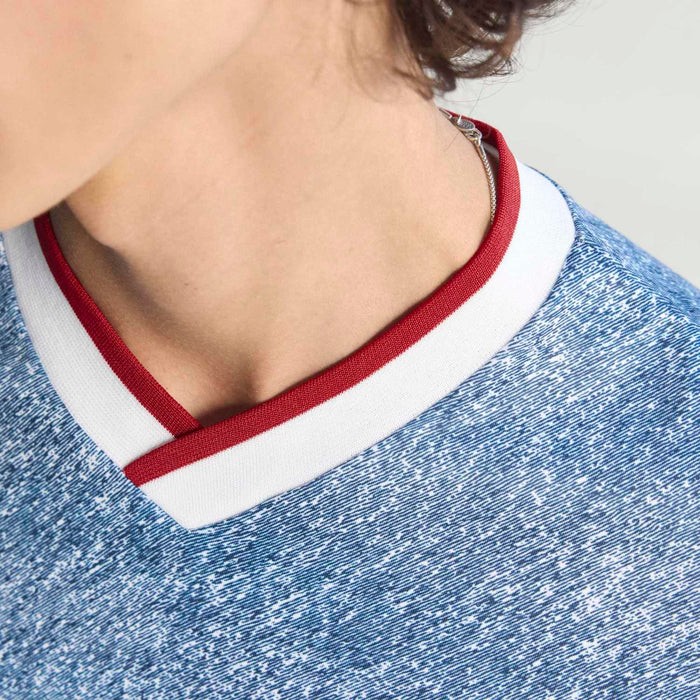 Men's denim jersey V-neck with red-and-white trim and textured star-print fabric
