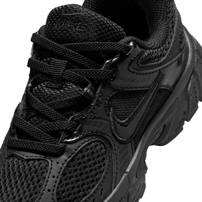Close-up of kids black lace-up running shoes: mesh upper, eyestays, and swoosh