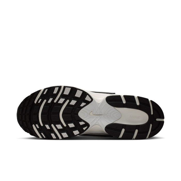 Men's running shoe outsole, black tread with white foam midsole and dark side stripes