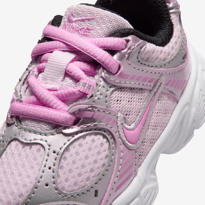 Toddler running shoe close-up with pink laces, pink swoosh, and mesh upper