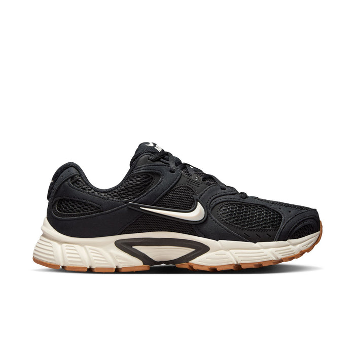 Black womens running sneakers, Nike swoosh on side, white midsole and gum outsole