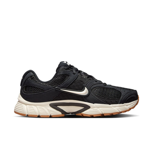 Black womens running sneakers, Nike swoosh on side, white midsole and gum outsole