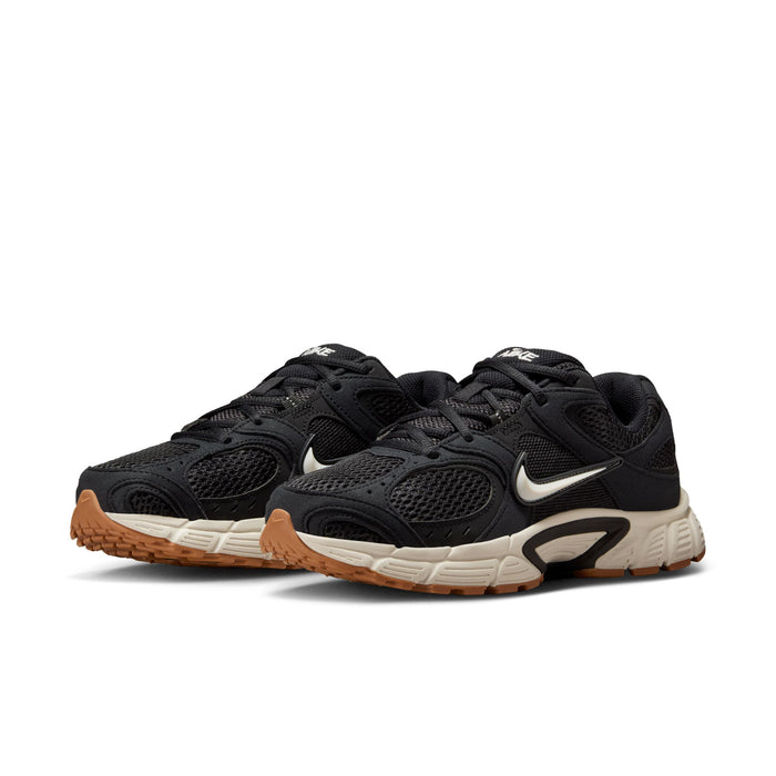 Black womens sneakers in pair view, Nike swoosh, white midsole and brown outsole