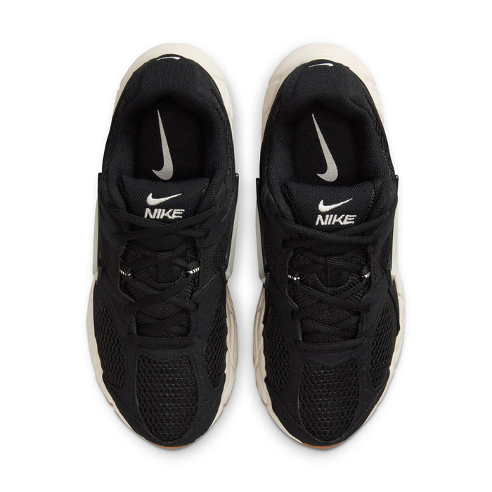 Black womens sneakers with Nike tongue branding, white midsole edge, lace-up