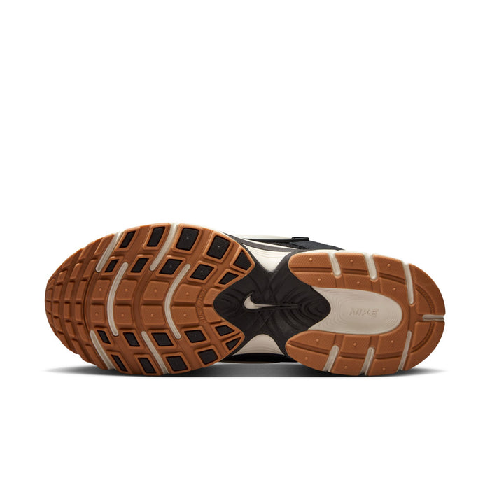 Black womens sneakers with brown tread outsole and white midsole underside view