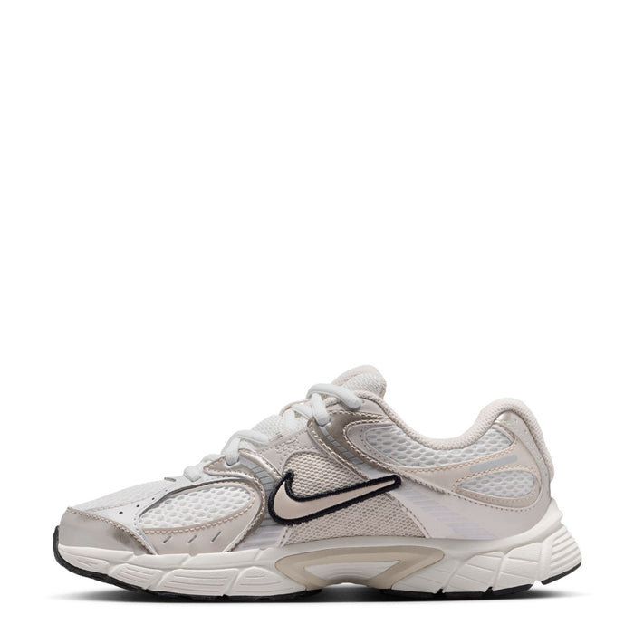 Youth white running sneaker, angled side view with black swoosh and lace-up front