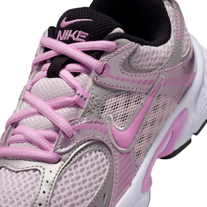 Youth running shoe close-up, pink laces and mesh upper with stitched overlays