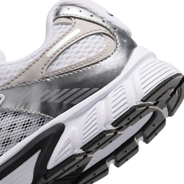 Close-up side view of youth sneaker midsole and outsole with black accent trim