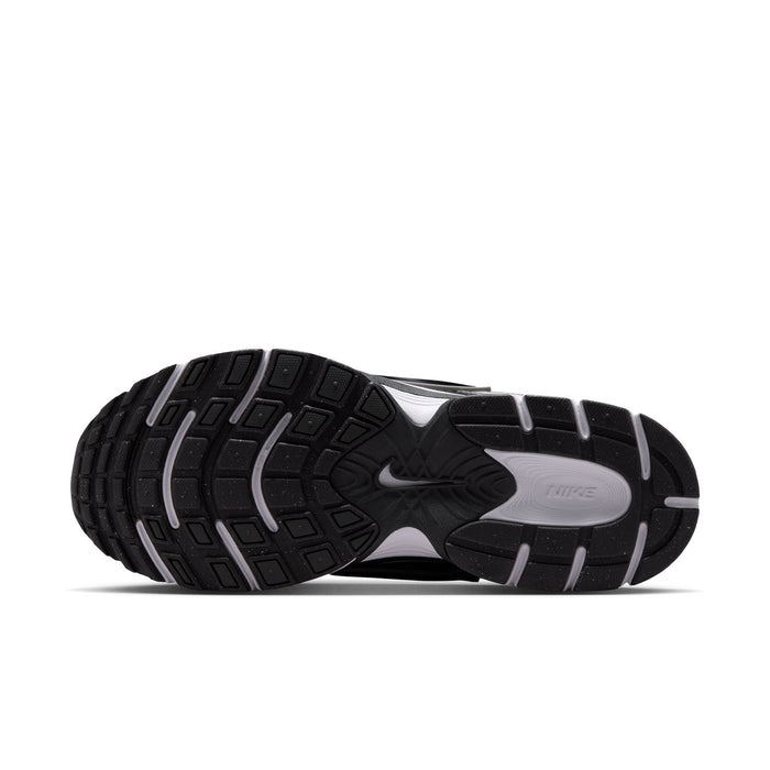 Men's running shoe outsole in black with white midfoot and grooved traction pattern.