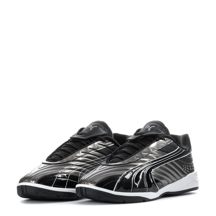 Youth sneakers pair, black with silver accents, lace-up with strap, white sole