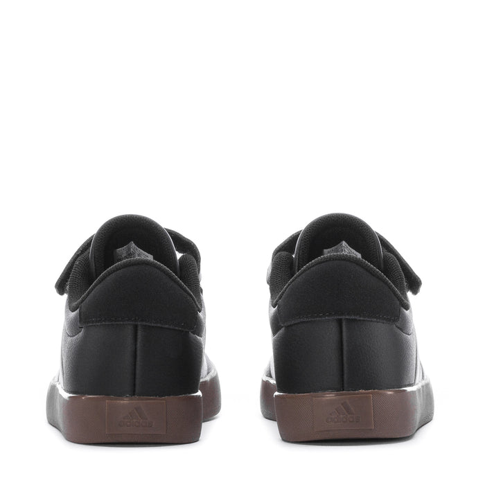 Kids' black sneakers back view with Velcro strap detail and gum heel tab