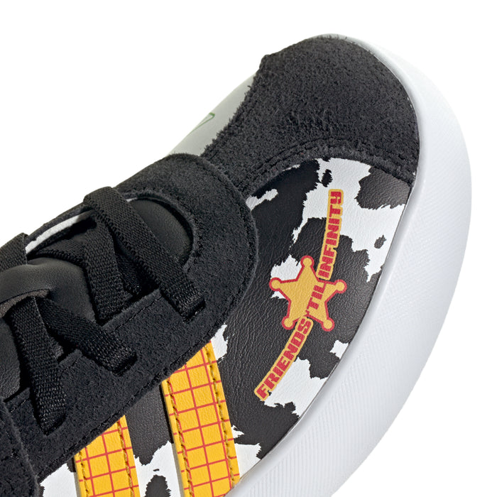 Kids' sneaker close-up: cow-print side with Friends for Life graphic, black upper