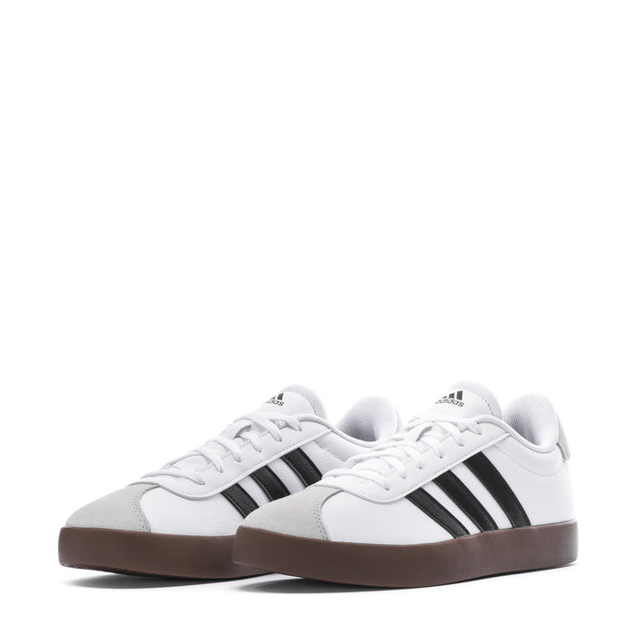 Youth adidas sneakers, front close-up: white upper, black stripes, gum sole