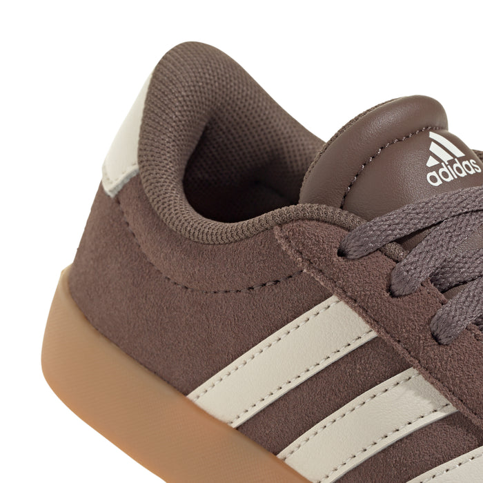 Close-up youth adidas sneaker upper, dark brown suede with cream stripes and laces.