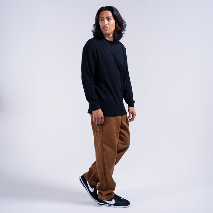 Men's brown work pants on model, loose fit with cargo pockets