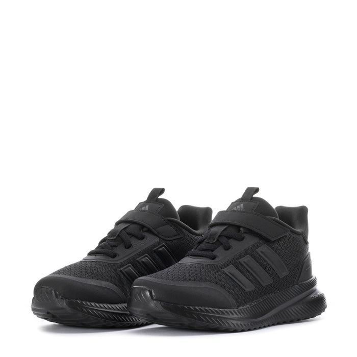 Pair of kids black sneakers with velcro strap and chunky patterned sole