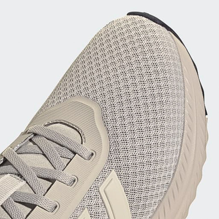 Men's sneaker upper close-up showing light grey knit texture and mint lace panel