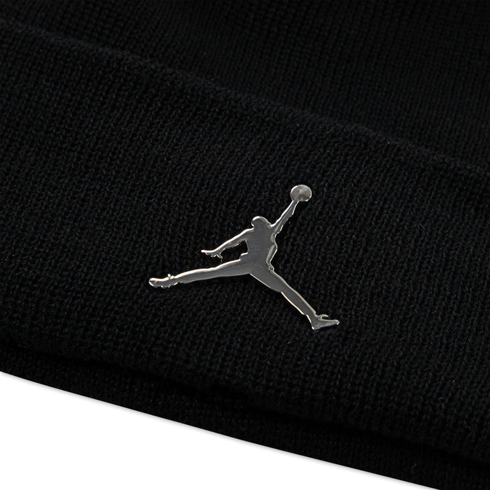 Black knit cuffed beanie with silver Jumpman logo close-up