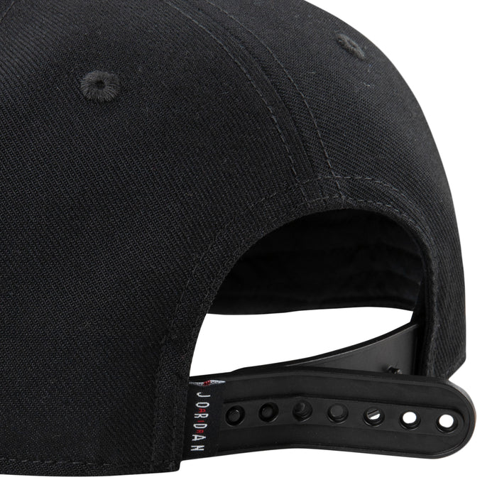 Black snapback side view showing open back strap and 'JORDAN' label