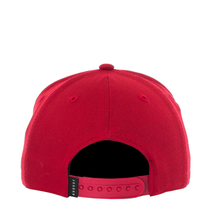 Youth red snapback cap with adjustable strapback and small black logo patch