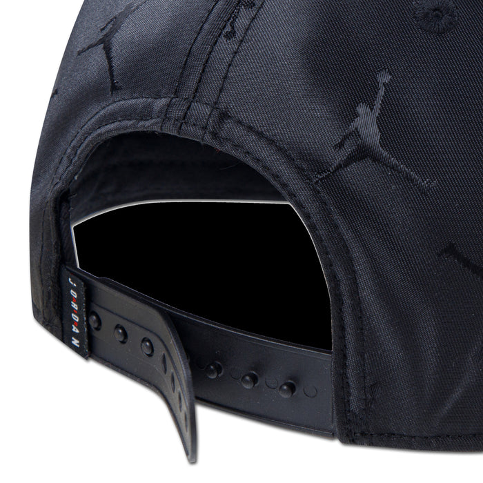 Youth black snapback cap close-up of adjustable strap with hole row