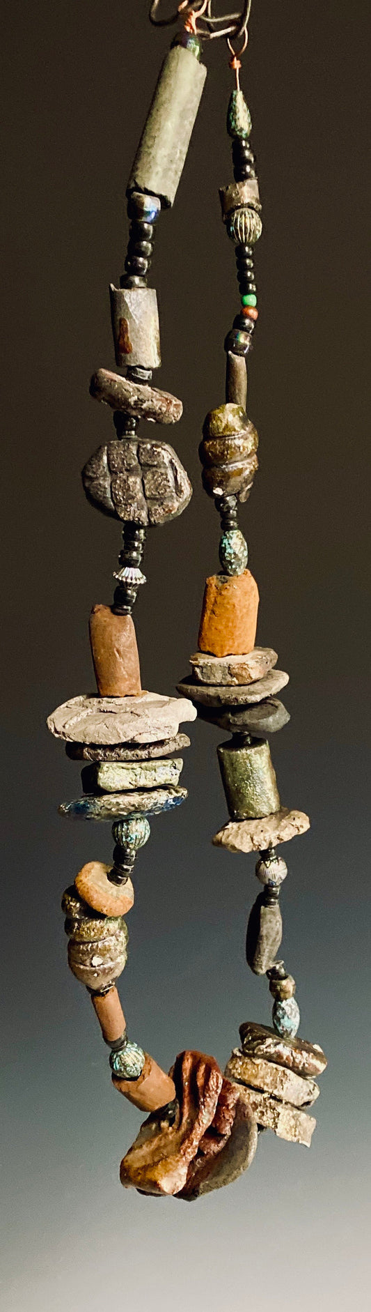 This one is nice! 24” long 12" vertical drop  over 35 multi colored raku beads Tribal!